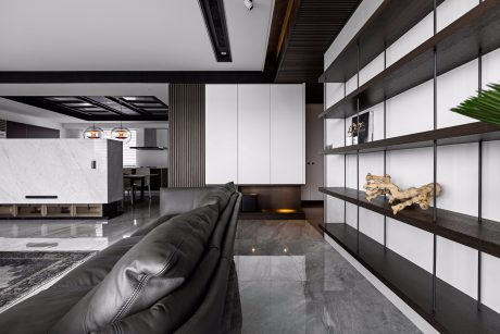 Sleek, modern interior with minimalist design, dark wood accents, and floating shelves.