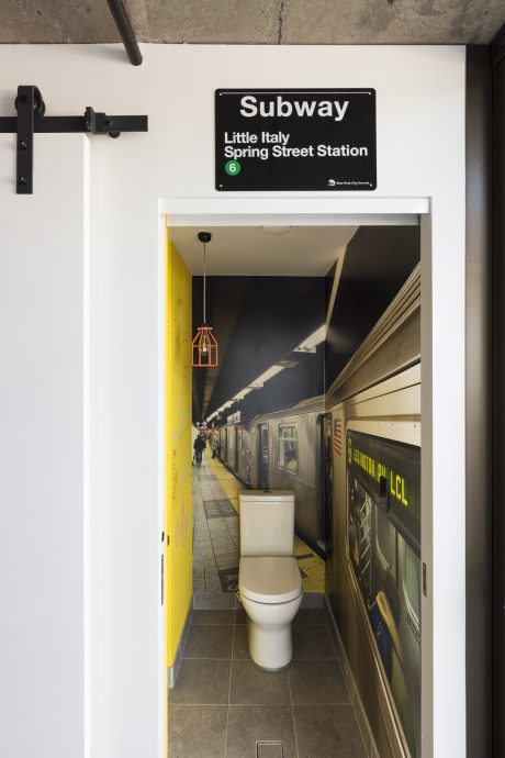 Subway station platform with minimalist, industrial-style design and a quirky toilet.