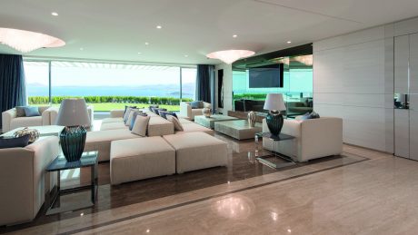 Stunning modern living room with panoramic views, sleek furniture, and elegant lighting.