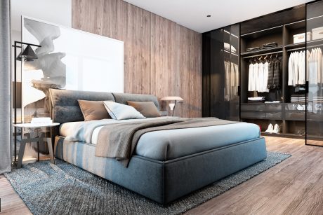Sleek, modern bedroom with wooden wall panels, large bed, and an open wardrobe.