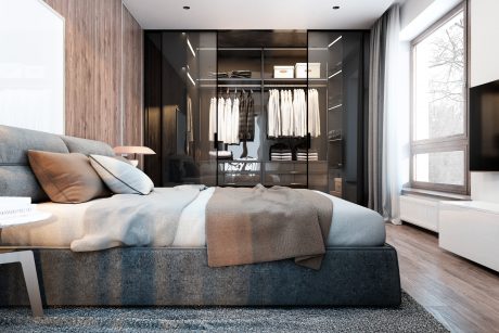 Modern, sleek bedroom with large closet, plush gray bedding, and floor-to-ceiling window.