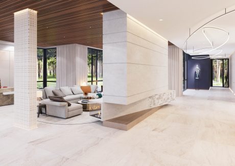Spacious modern lobby with sleek marble floors, wood paneling, and contemporary lighting.