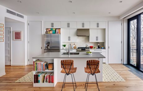 Bright, modern kitchen with white cabinets, stainless appliances, and wooden accents.