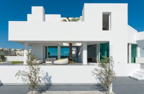 Striking modern residence with clean lines, open layout, and lush landscaping.