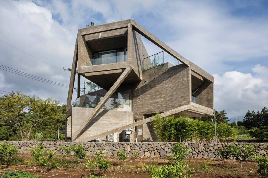 A unique modern concrete and glass structure with an angular and geometric design.
