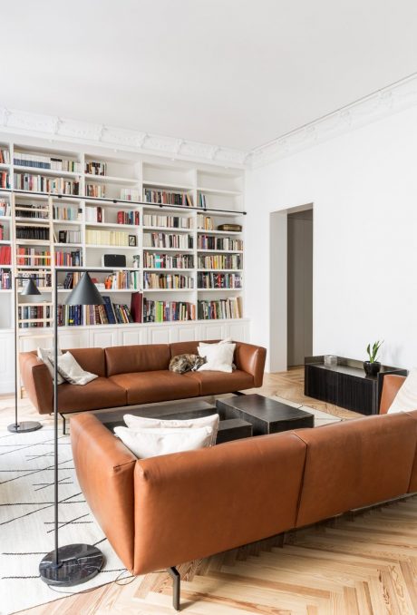 Well-designed modern living room with built-in bookshelves, leather sofas, and sleek furniture.