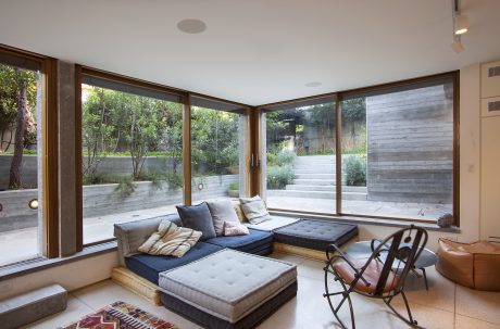 Spacious living room with large windows, plush seating, and an inviting outdoor view.
