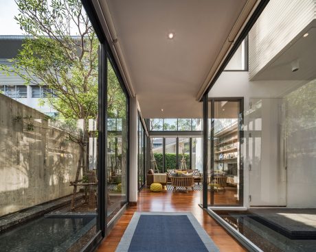 Expansive glass walls offer a seamless transition between indoor and outdoor spaces.