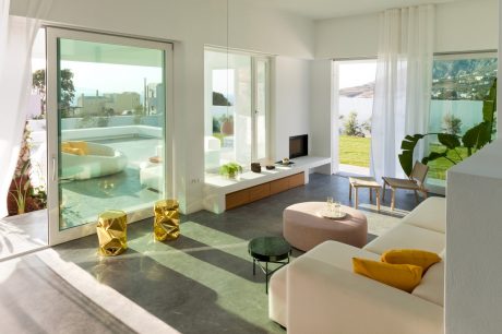 Bright, modern living room with open floor plan, large windows, and contemporary furnishings.