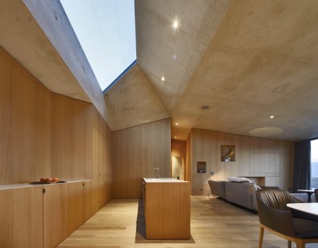 Spacious, modern interior with clean lines, wood paneling, and natural lighting.