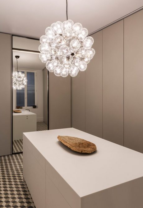 Elegant modern lighting fixture illuminates sleek, minimalist interior design.