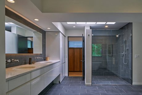 Modern bathroom design with sleek vanity, large shower, and natural lighting.