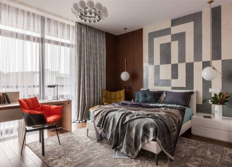 Elegant bedroom with modern lighting, geometric wall art, and plush bedding.