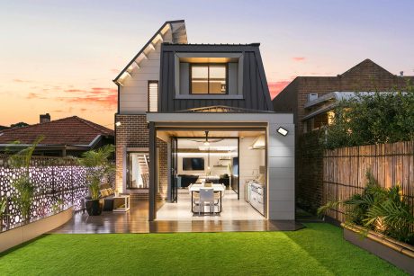 Contemporary home with unique roofline, open interior layout, and landscaped outdoor area.