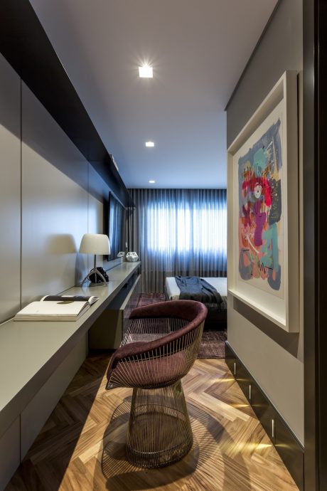 Sleek, modern bedroom with minimalist furnishings, colorful artwork, and intricate lighting design.