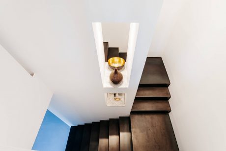 Sleek modern staircase with geometric lighting feature and decorative accents.