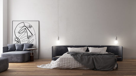 Minimalist bedroom design with modern art, textured bedding, and wood flooring.