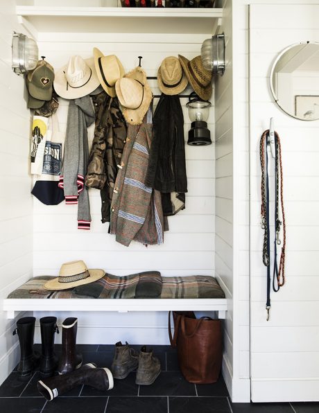Bright, organized mudroom with shelves, hooks, and storage for coats, hats, and shoes.