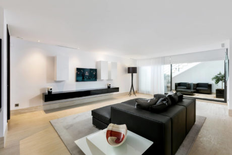 Sleek, minimalist living space with clean lines, neutral tones, and integrated entertainment system.