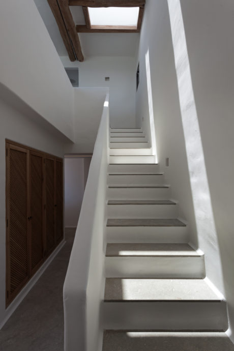 A modern, minimalist staircase with clean lines and natural lighting.
