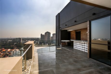 Sleek modern architecture with floor-to-ceiling windows, minimalist furniture, and city view.