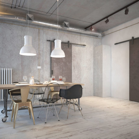 A modern, industrial-inspired dining space with concrete walls, pendant lights, and a mix of metal and wooden furniture.