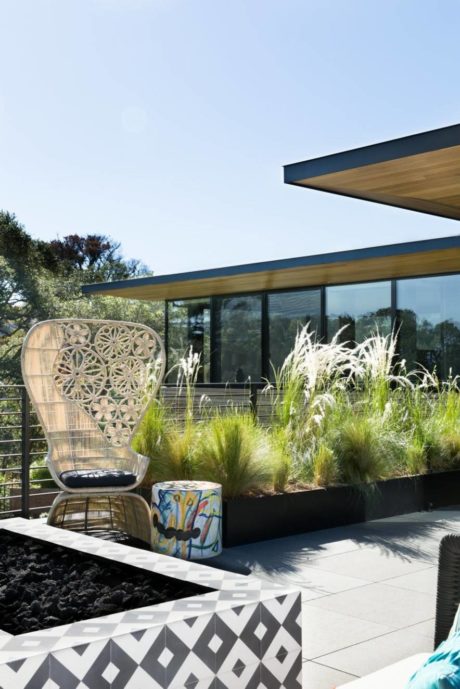 Sleek modern architecture with textured materials, geometric patterns, and lush greenery.