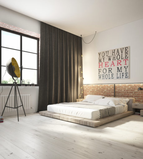 Minimalist bedroom with a platform bed, dark curtains, and a large motivational wall sign.