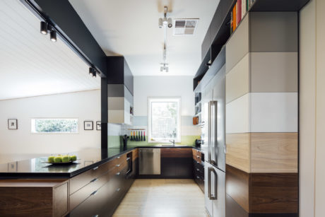 Sleek, modern kitchen with clean lines, natural wood accents, and large window.