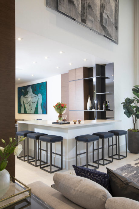 Stylish modern living room with a custom bar area, art, and decorative accents.