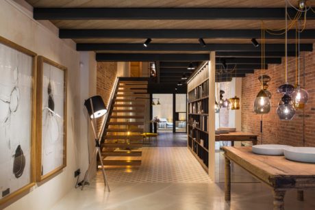 Rustic, industrial-style space with exposed brick, wooden beams, and eclectic lighting.