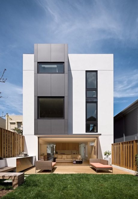 Contemporary two-story house with an open living area and large windows.