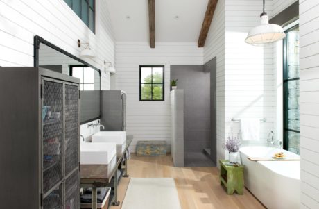 Modern bathroom interior with dual sinks, freestanding tub, and a mix of
