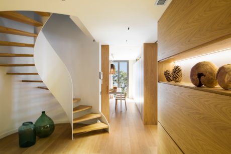Contemporary wooden staircase with sleek white balustrade.