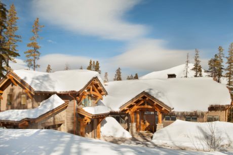 Snow-covered wooden cabins in a winter landscape.