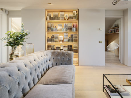 Elegant living room with a tufted sofa and built-in bookshelves