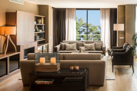 Chic living room with neutral tones and large windows.