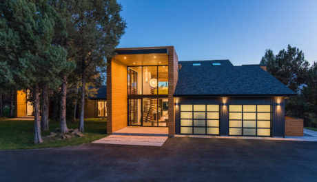 Modern house with large windows at twilight.