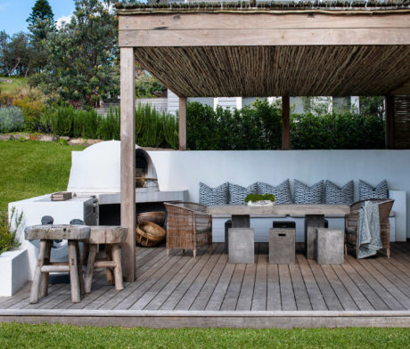 Contemporary outdoor living space with built-in fireplace and seating.