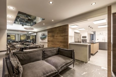 Sleek interior with open-plan dining, kitchen, and living space with wood