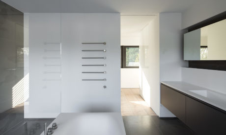 Minimalist white kitchen with sleek cabinets and natural light.