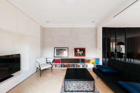 Elegant living room with minimalist decor and colorful art.