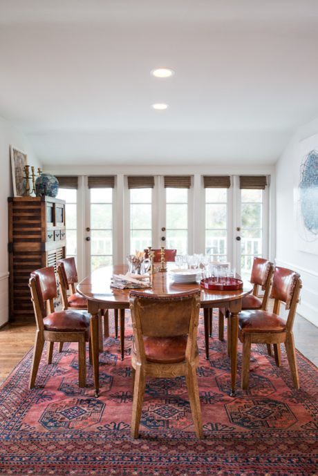 Cozy dining room with a wooden table, chairs, and an oriental rug