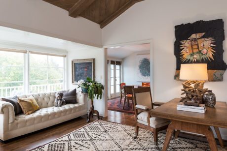 Contemporary living room with chesterfield sofa and wooden accents.