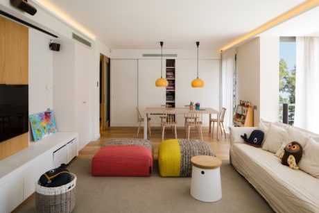 Contemporary living room with colorful accents and sleek design.