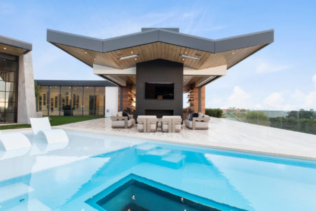Contemporary house with cantilevered roof and pool.