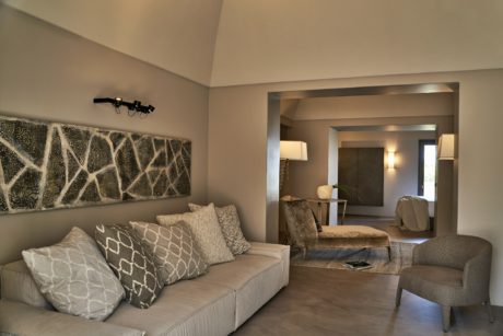 Contemporary living room with neutral tones and abstract wall art.