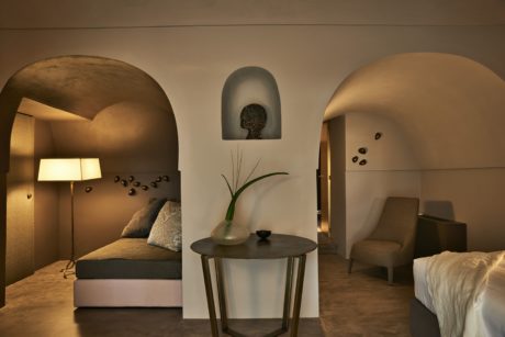 Modern room with arched doorways, subdued lighting, and minimalist decor.