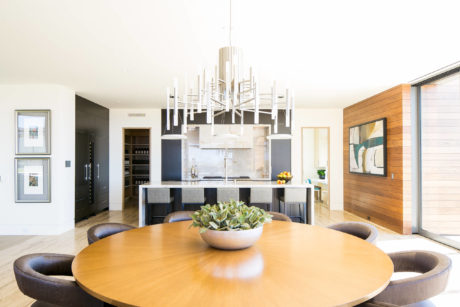 Contemporary kitchen with a round dining table and pendant lighting.