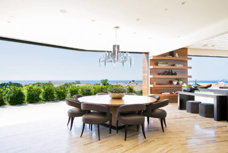 Contemporary dining area with an open wall view to the outdoors.